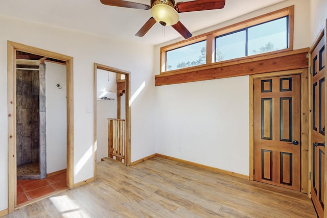 entrance foyer featuring light wood-style flooring, baseboards, and a ceiling fan