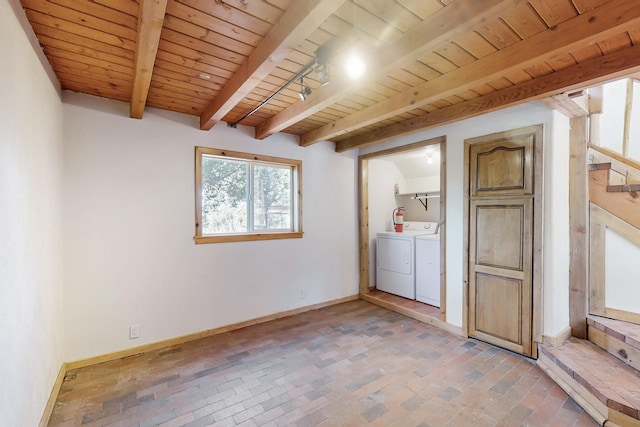 washroom featuring brick floor, washer and clothes dryer, wooden ceiling, laundry area, and baseboards