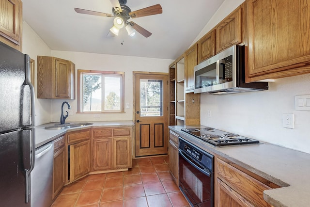 kitchen featuring brown cabinets, light tile patterned floors, light countertops, a sink, and black appliances