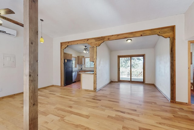 unfurnished living room with light wood finished floors, baseboards, lofted ceiling, ceiling fan, and a wall mounted AC