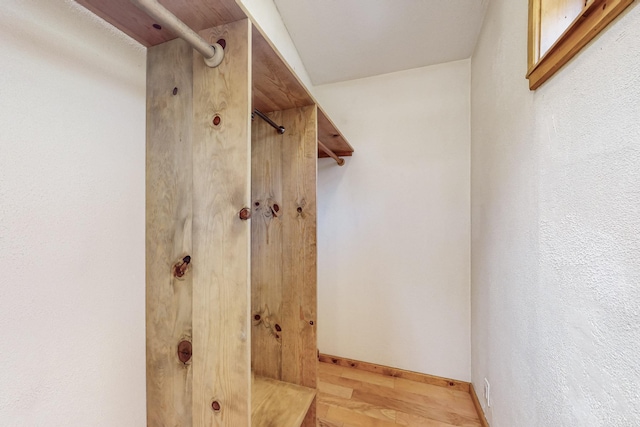 bathroom featuring wood finished floors and baseboards