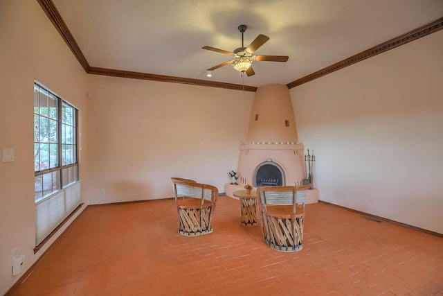 unfurnished room featuring ceiling fan, ornamental molding, a fireplace, and baseboards