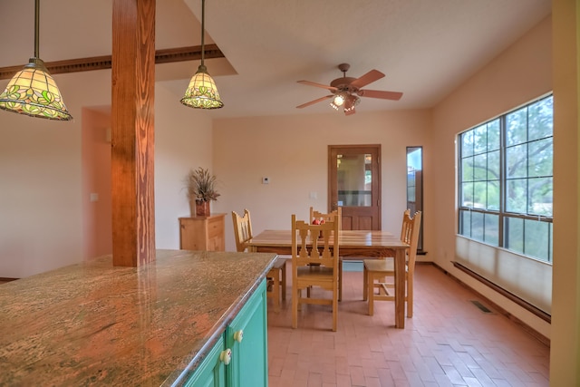 dining area with a baseboard heating unit, brick floor, and a ceiling fan