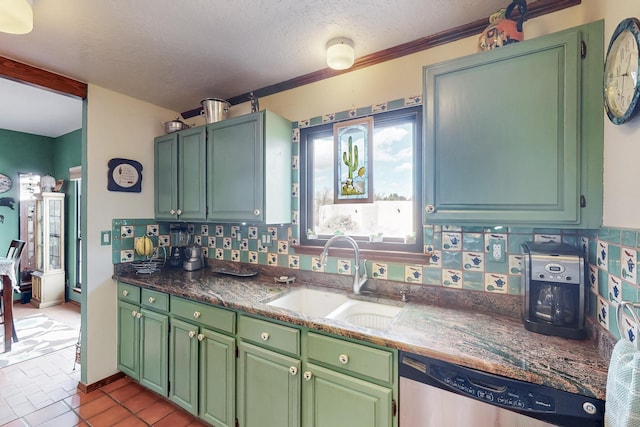 kitchen with a textured ceiling, a sink, dishwasher, tasteful backsplash, and green cabinetry