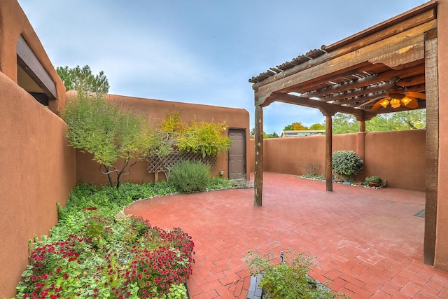 view of patio featuring a ceiling fan, a fenced backyard, and a pergola