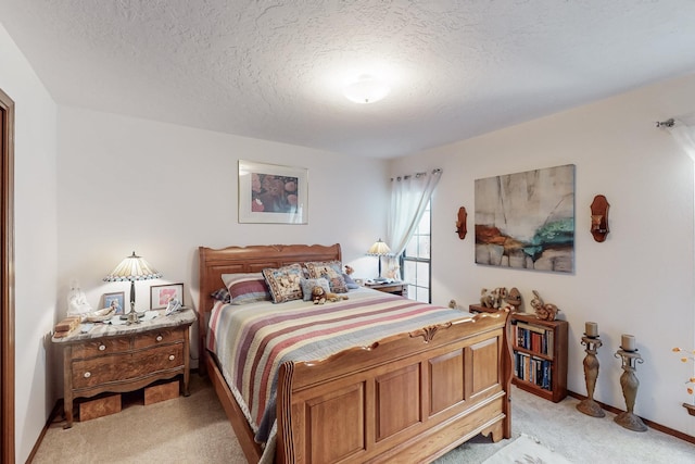 bedroom featuring light carpet and a textured ceiling