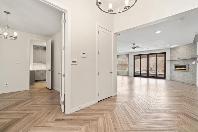 hallway featuring baseboards, a notable chandelier, and recessed lighting