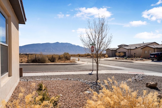 exterior space with a mountain view and curbs