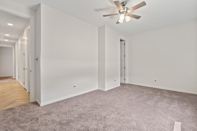 unfurnished room with light carpet, recessed lighting, a ceiling fan, and baseboards