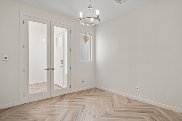 interior space featuring french doors, baseboards, and an inviting chandelier