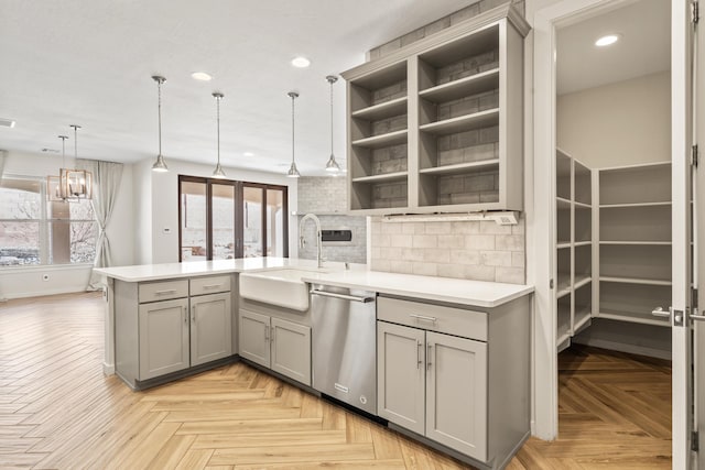 kitchen featuring decorative light fixtures, gray cabinets, light countertops, open shelves, and stainless steel dishwasher