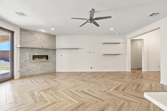 unfurnished living room featuring a ceiling fan, visible vents, a fireplace, and baseboards