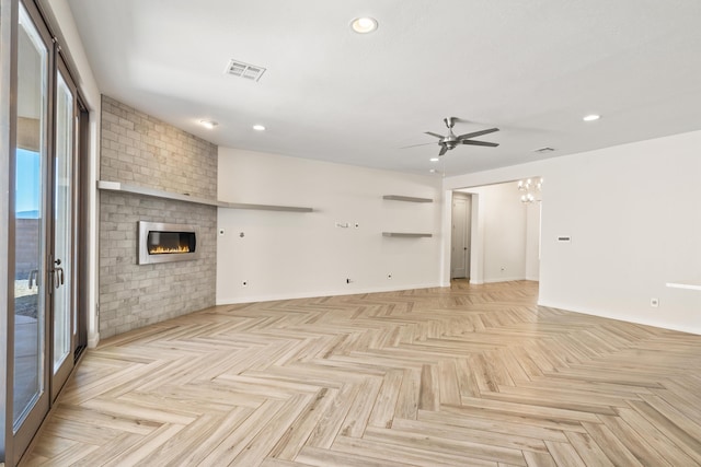 unfurnished living room featuring a brick fireplace, visible vents, a ceiling fan, and recessed lighting