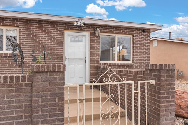 property entrance with brick siding