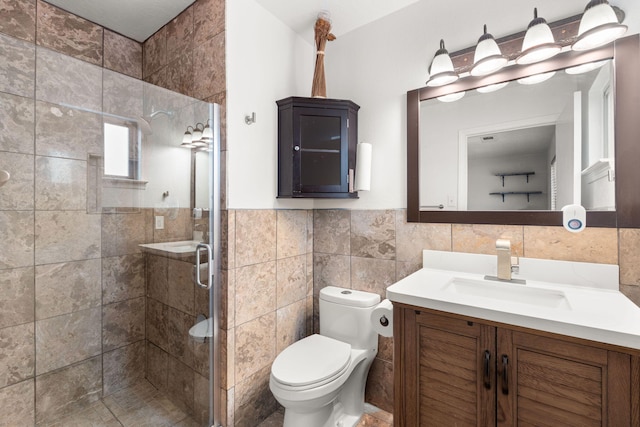 full bathroom with toilet, a wainscoted wall, vanity, tile walls, and a shower stall