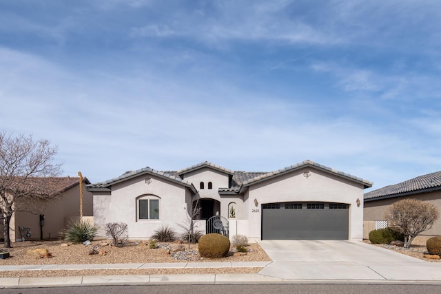 mediterranean / spanish home with driveway, a tiled roof, an attached garage, and stucco siding