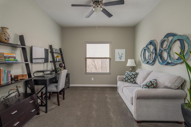 office area featuring a textured ceiling, dark carpet, a ceiling fan, and baseboards