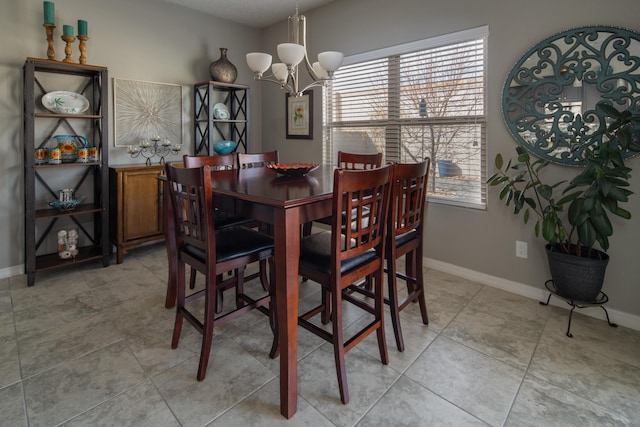 dining room featuring an inviting chandelier, baseboards, and light tile patterned flooring