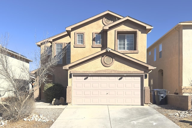 view of front facade featuring driveway, a garage, and stucco siding