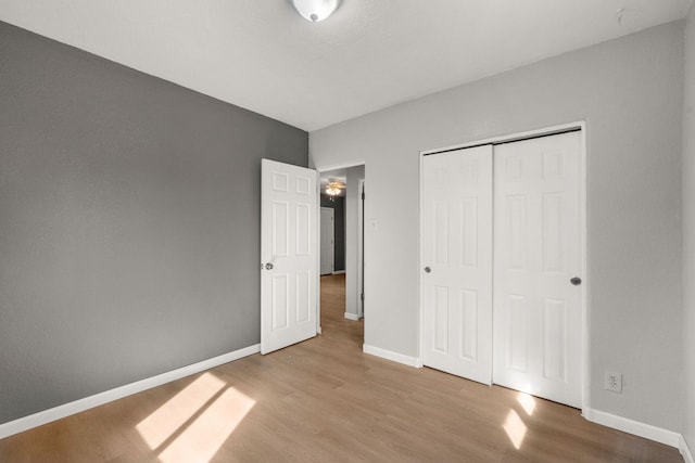 unfurnished bedroom with baseboards and light wood-style floors