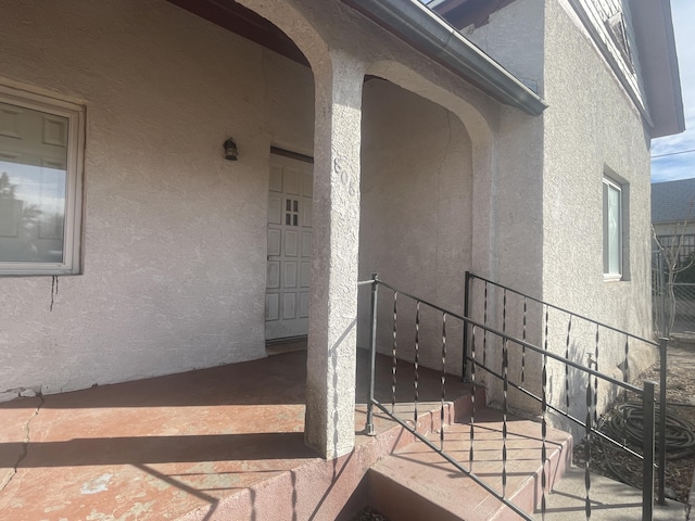 property entrance featuring stucco siding