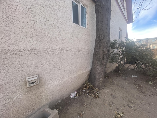 view of side of home featuring stucco siding