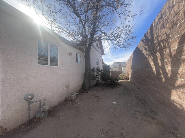 view of side of home with stucco siding