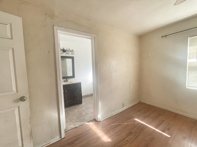 empty room featuring a sink and light wood-style flooring