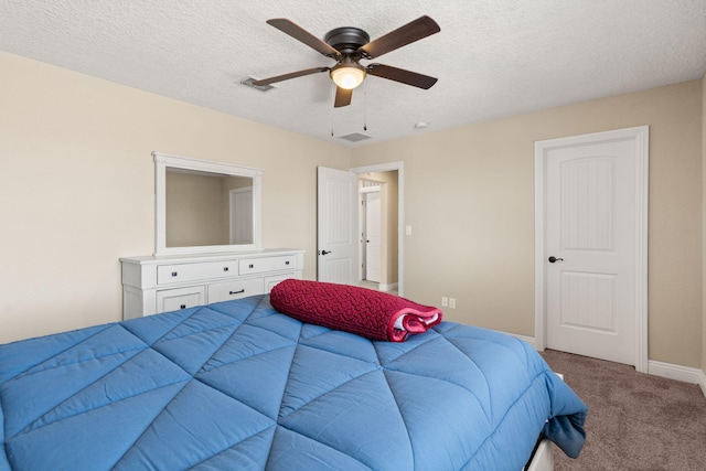 carpeted bedroom with a ceiling fan, baseboards, visible vents, and a textured ceiling