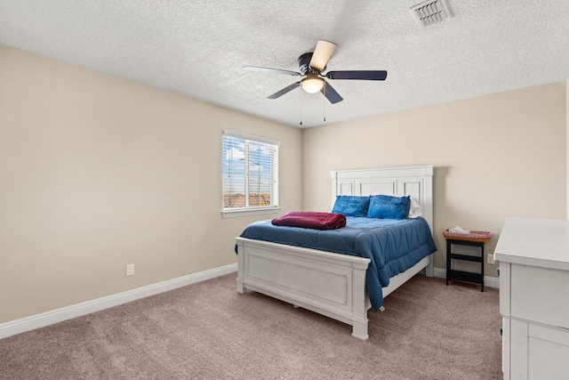 bedroom featuring baseboards, visible vents, a ceiling fan, light colored carpet, and a textured ceiling