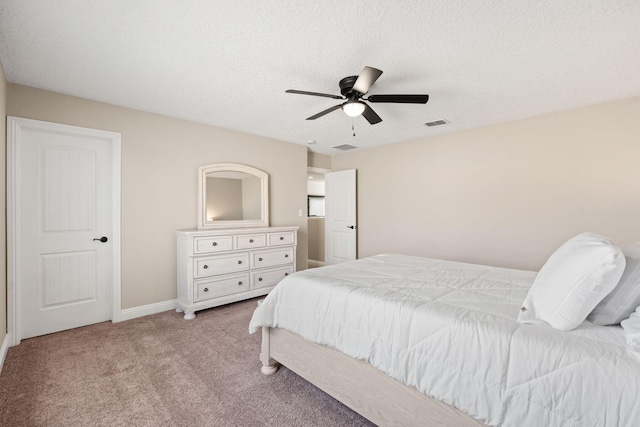 bedroom with a textured ceiling, ceiling fan, carpet floors, visible vents, and baseboards