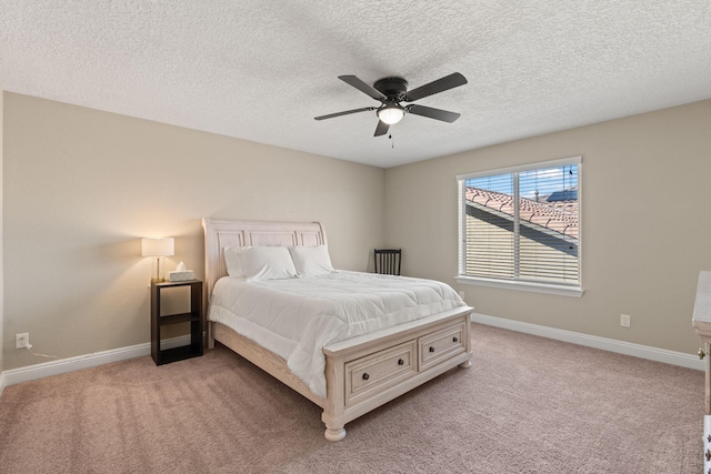 bedroom featuring a ceiling fan, light carpet, and baseboards