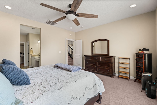 carpeted bedroom featuring baseboards, visible vents, a textured ceiling, and recessed lighting