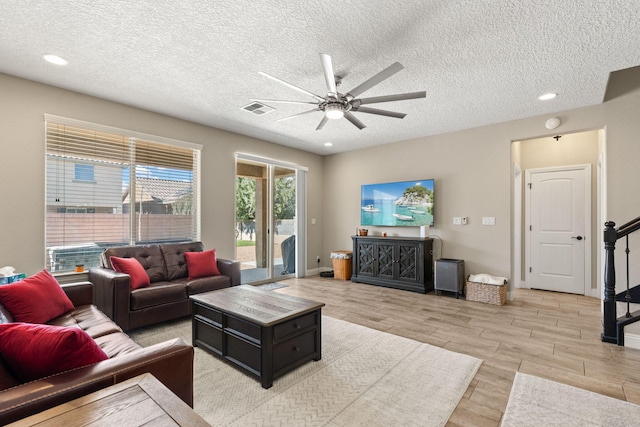 living area featuring visible vents, ceiling fan, wood tiled floor, stairs, and recessed lighting