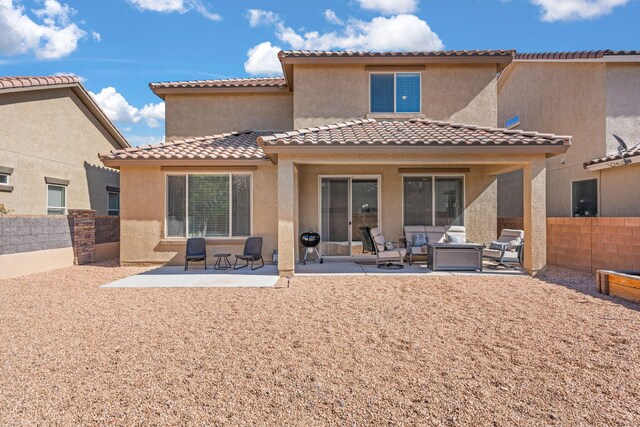 rear view of house with a patio area, an outdoor living space, and stucco siding