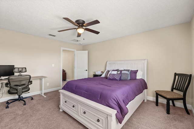 bedroom featuring baseboards, visible vents, a ceiling fan, light colored carpet, and a textured ceiling