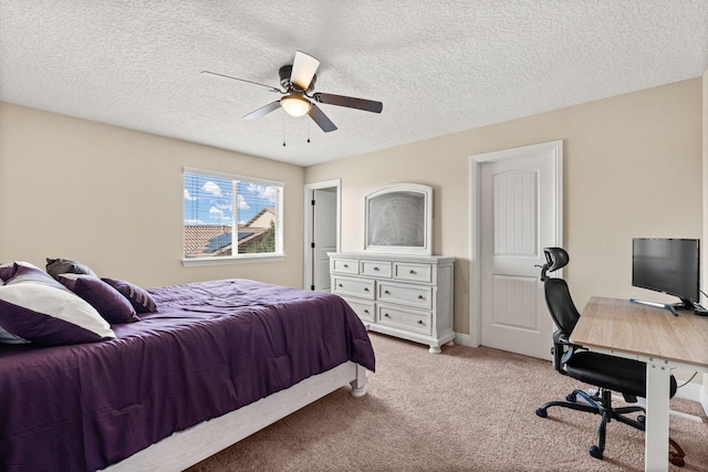 carpeted bedroom with a ceiling fan and a textured ceiling