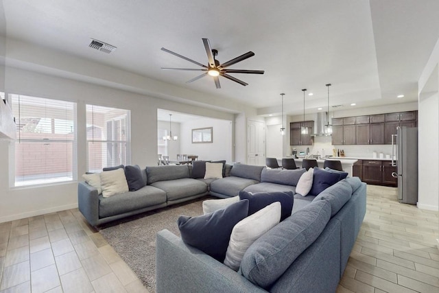 living room with a ceiling fan, recessed lighting, visible vents, and baseboards