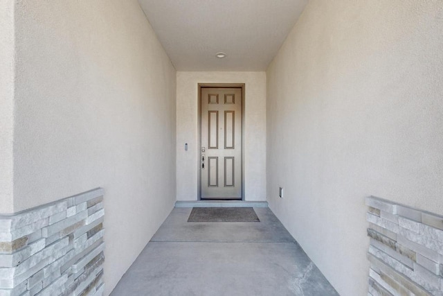 property entrance featuring stucco siding