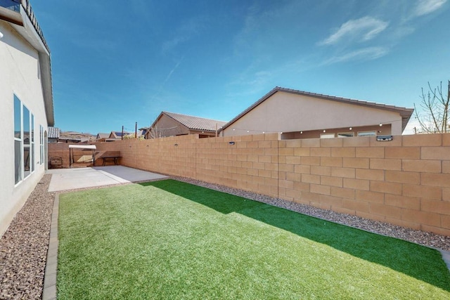 view of yard with a patio and a fenced backyard