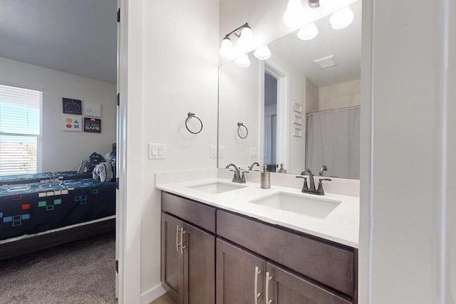 bathroom with a sink, double vanity, and connected bathroom