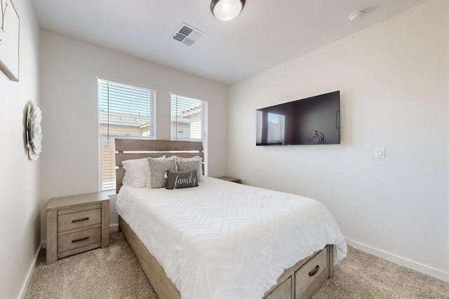 bedroom with light carpet, visible vents, and baseboards