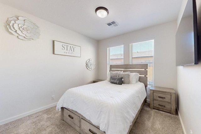 bedroom with light colored carpet, visible vents, and baseboards