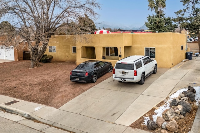 pueblo revival-style home with stucco siding