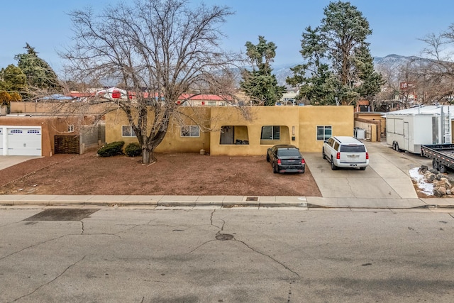 pueblo-style house with a mountain view and stucco siding