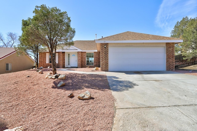 single story home with brick siding, driveway, and an attached garage