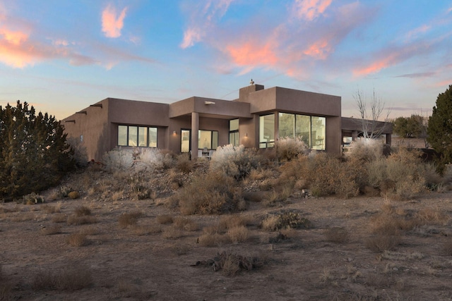 pueblo-style home featuring stucco siding