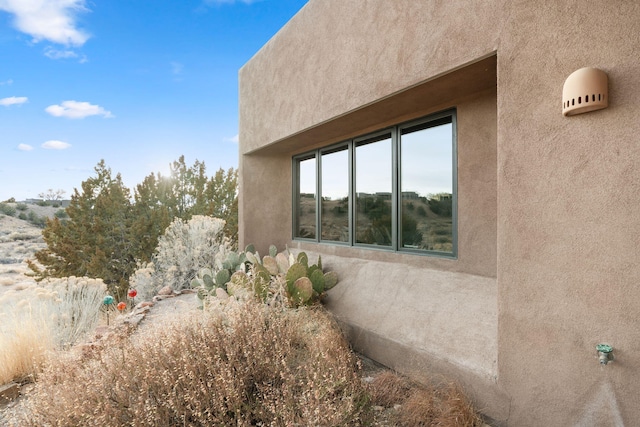 view of side of home with stucco siding