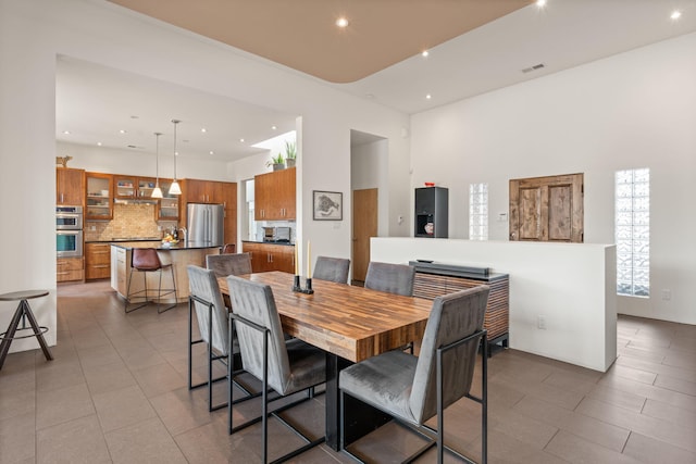 dining space with light tile patterned flooring, visible vents, and recessed lighting