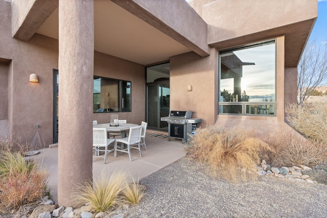 view of patio with grilling area and outdoor dining space